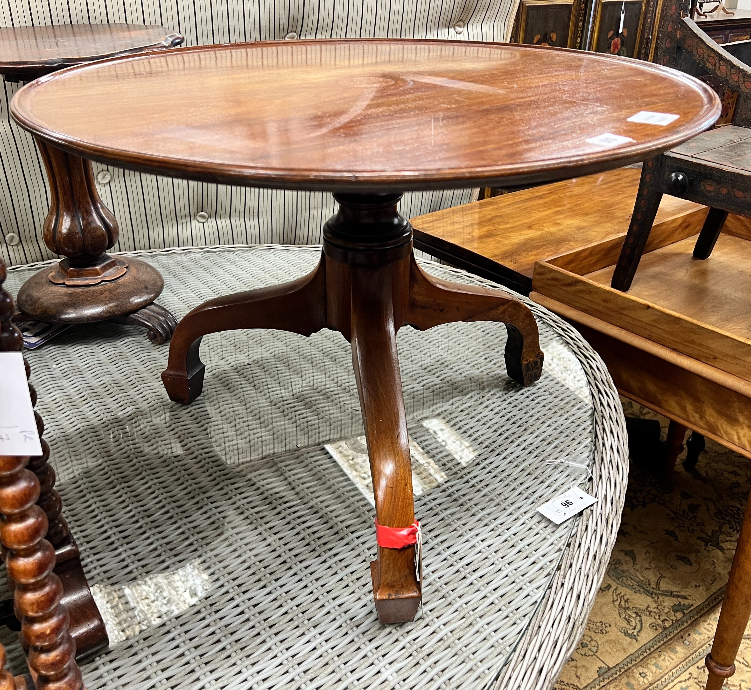 An early Victorian mahogany dish top tea table, diameter 69cm, height 47cm (cut down, converted from a dumb waiter) and a Victorian Sutherland table, width 55cm, depth 16cm, height 63cm